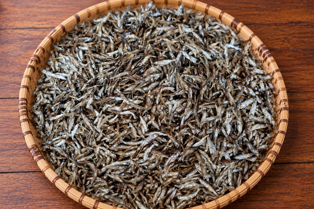Sun-dried omena displayed in a woven tray